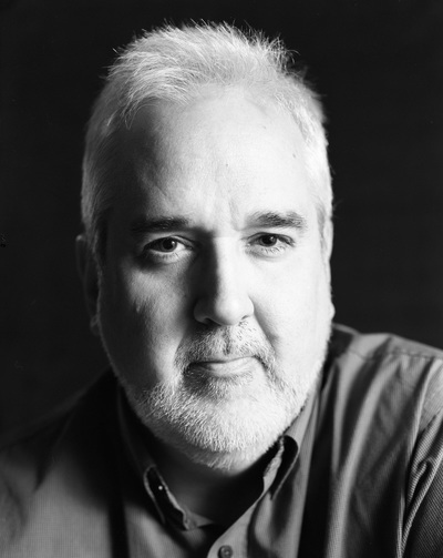 Front facing face only portrait in black and white of a gray haired white man