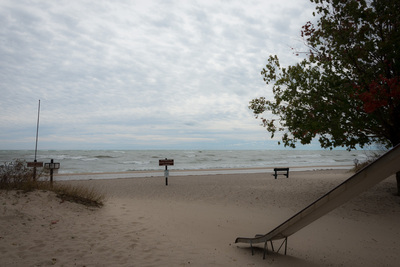 A beach playground has slides and benches but no people