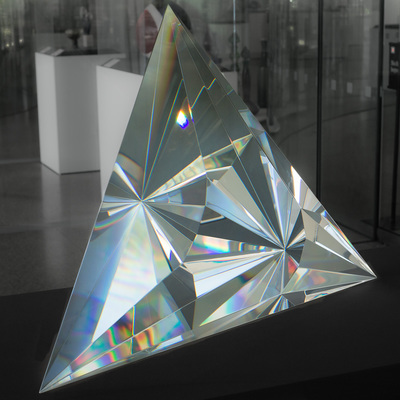 Large triangular shiny piece with smaller facets inside