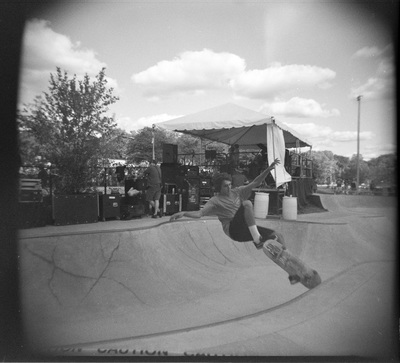 A young man gets some air in a bowl that is behind the band tent