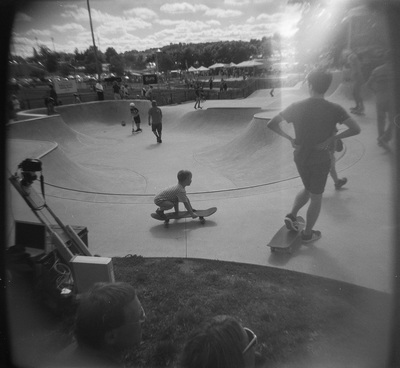 Kids on skateboards in a concrete bowl